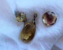 A large pear shaped citrine pendant, on a white metal loop,