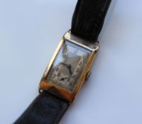 A Gentleman's 9ct yellow gold wristwatch, with a rectangular silvered dial and Arabic numerals,