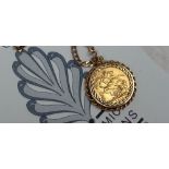 A George V gold sovereign, on a 9ct yellow gold chain and mount,