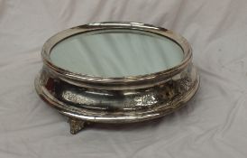 An electroplated wedding cake stand, of circular form with a mirrored plateau,