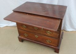 A George III style mahogany chest the rectangular planked top above a brushing slide and three