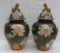 A pair of Japanese Satsuma vases and covers, the domed cover with Dog of Foo terminal,