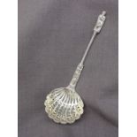 A Victorian silver apostle sifting spoon, with a twisted stem and a pierced shell shaped bowl,