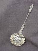 A Victorian silver apostle sifting spoon, with a twisted stem and a pierced shell shaped bowl,