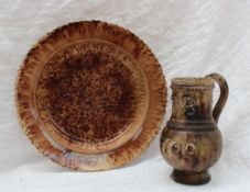 A Wheildon pottery plate, with a shaped rim and a mottled brown ground, 22.