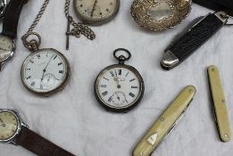 A continental white metal open faced pocket watch, the enamel dial with Roman numerals,