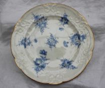 A Nantgarw porcelain plate painted with sprays of cornflower blue flowers to a moulded border and