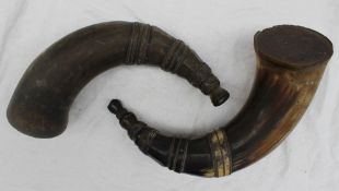 A pair of horn flasks, sealed to one end, carved with bands and facets,