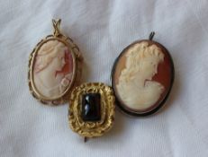 Two cameo brooches of maidens in profile together with a Victorian yellow metal brooch