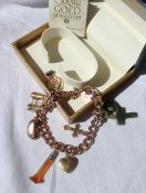 A 9ct yellow gold charm bracelet set with various charms including a bean, binoculars, corkscrew,