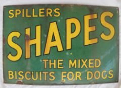An enamel sign with black edged yellow text for "Spillers Shapes the mixed biscuits for dogs" on a