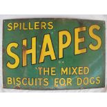 An enamel sign with black edged yellow text for "Spillers Shapes the mixed biscuits for dogs" on a