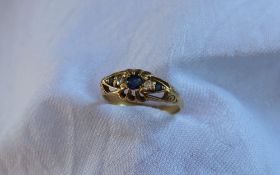 A sapphire and diamond ring, set with a central sapphire,