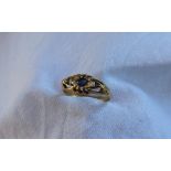 A sapphire and diamond ring, set with a central sapphire,