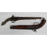 A flintlock pistol with a pierced and wirework butt, with scrolling and leaf decoration,