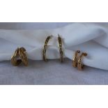 A pair of 9ct yellow gold twist earrings, together with two other pairs of yellow metal earrings,