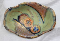 A Carlton Ware 'Bell' Revo bowl, with a mottled light green ground, three flower heads,