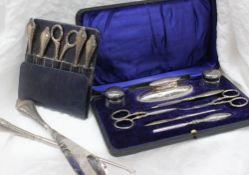 An Edward VII silver nail kit, with hammered decoration, including a nail buffer,