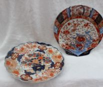 A Japanese Imari dish with a shaped edge, decorated with a central vase of flowers,