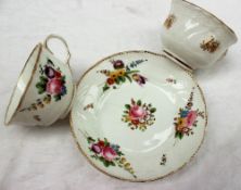 A Swansea porcelain teacup and saucer, decorated with a dentil gilt rim, sprays of garden flowers,