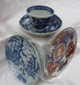 A Japanese Imari style plate with a central dragon, and three panels of oriental figures,