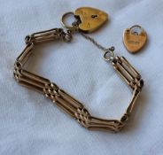 A 9ct yellow gold gate bracelet with three bars and a padlock clasp,