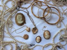 Assorted costume jewellery including faux pearls, cameo brooches, gold plated hinged bangle,