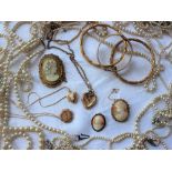 Assorted costume jewellery including faux pearls, cameo brooches, gold plated hinged bangle,