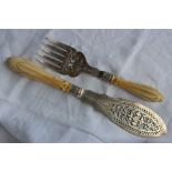 A pair of Victorian silver and ivory handled fish servers, with a pierced blade and tines,