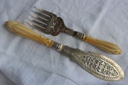 A pair of Victorian silver and ivory handled fish servers, with a pierced blade and tines,