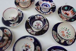 A collection of Gaudy Welsh teacups and saucers, various patterns including Basket of flowers,