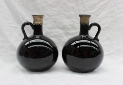 A pair of 19th century brown glass wine bottles with electroplated rim and ring handle, 18.