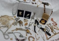 Assorted costume jewellery including brooches, necklaces, watches bracelets,