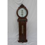 A 19th century oak "American Forecast Barometer" by Joseph Davis & Co.