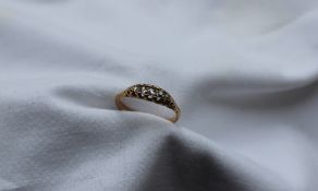 A five stone diamond ring set with graduated round old cut diamonds to an 18ct yellow gold setting