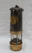 A Thomas & Williams Type No.4 steel and brass miners lamp, No.