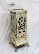 An Art Nouveau greenhouse heater, inset with a green floral decorated tile to the top,