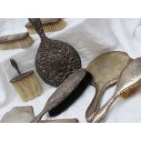 A George VI silver backed dressing table hand mirror together with a matching hair brush,
