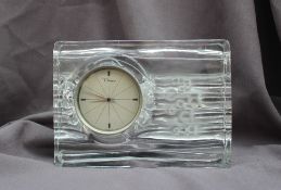 A Daum glass mantel clock the round dial having dauphine hands, with a brushed steel bezel,