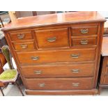 An Edwardian walnut chest with an arrangement of five drawers above three long graduated drawers on