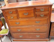 An Edwardian walnut chest with an arrangement of five drawers above three long graduated drawers on