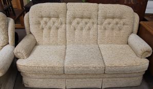A cream floral three seater settee and matching arm chair