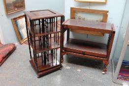 A metamorphic tea trolley together with a revolving bookcase