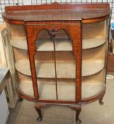 A 20th century mahogany display cabinet with bowed glass sides and a glazed door on cabriole legs