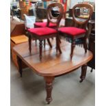 A Victorian mahogany dining table together with three Victorian balloon back dining chairs