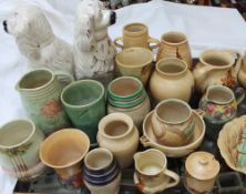 A collection of E Radford floral painted pottery together with a pair of Staffordshire spaniels