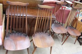 An oak drop leaf dining table together with a set of four Ercol dining chairs