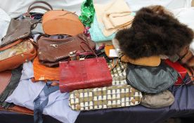 A collection of handbags, fur stoles,