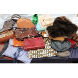 A collection of handbags, fur stoles,