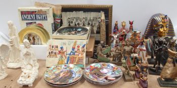 A collection of Egyptian inspired figures, collectors plates,